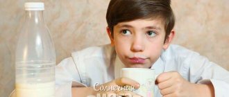 Doubting boy drinks milk, photo